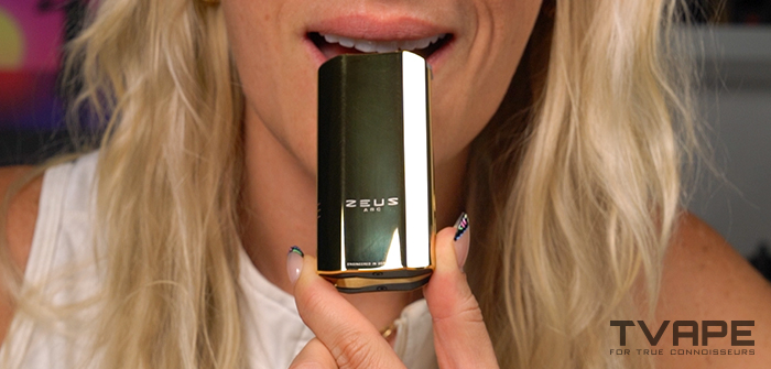 A woman is inhaling from the Zeus Arc GT4 portable vaporizer