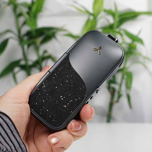 Hand holding an Airvape Legacy Pro 2 vaporizer.