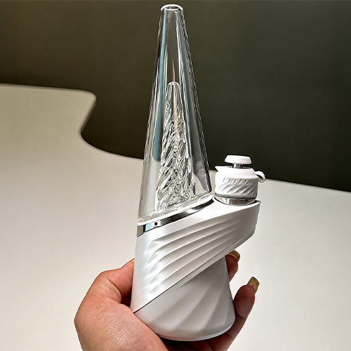 Woman holds up a Puffco Peak Pro 3DXL from the silicone base
