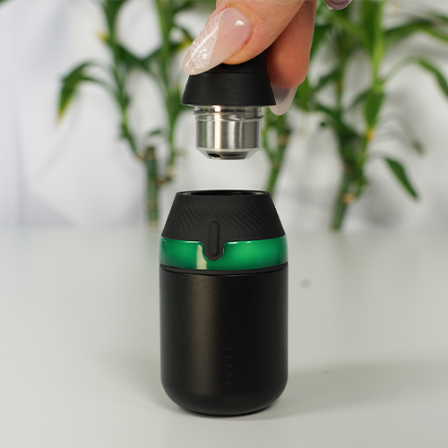 Puffco Proxy Core Kit dab pen is on hand while a woman is attaching its extended mouthpiece.