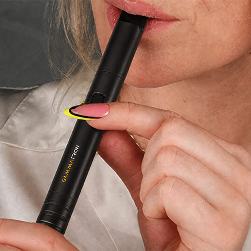 Woman inhaling from Tronian Gammatron with the extended mouthpiece.
