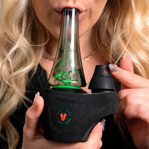 Woman inhaling from utillian 8 Turbo while spinning the dual spinner cap