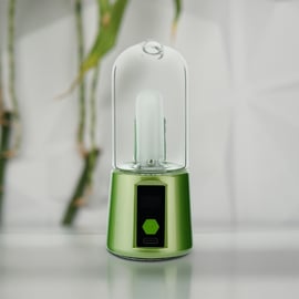 Front view of lime green BOMB Magloud E Rig, a portable electric dab rig with glass cup, digital display, and ergonomic base for efficient concentrate vaporization