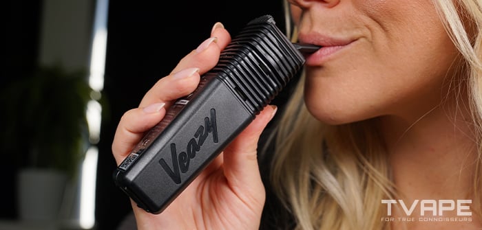 A woman is inhaling from the Veazy Vaporizer from Storz and Bickel
