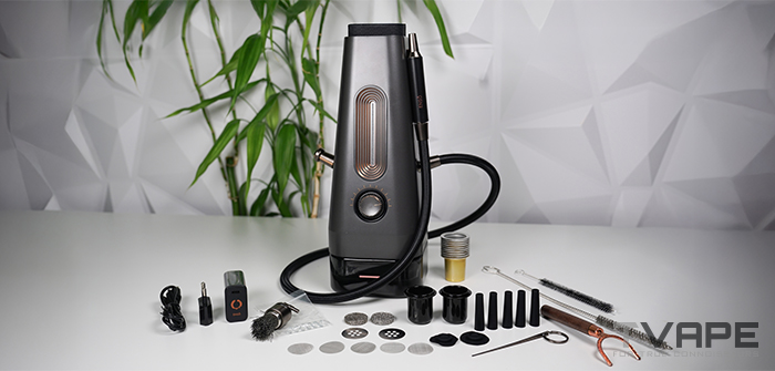 Complete AirVape Enso 2026 kit laid out on a white table: the electric shisha with coiled vapor hose, USB-C charger, spare ceramic cups, disposable aluminum cups, mesh screens, blowout valves, wooden mouthpiece stem, cleaning brushes, and multi-tool